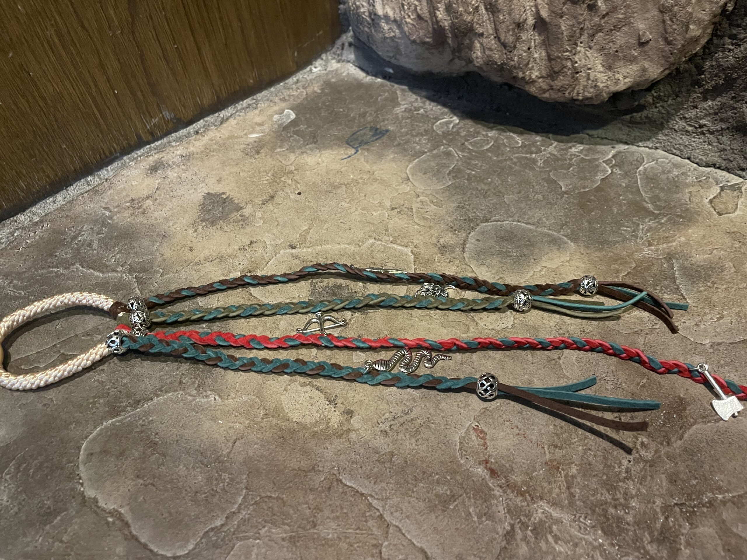 Hair-tie with leather braids and charms